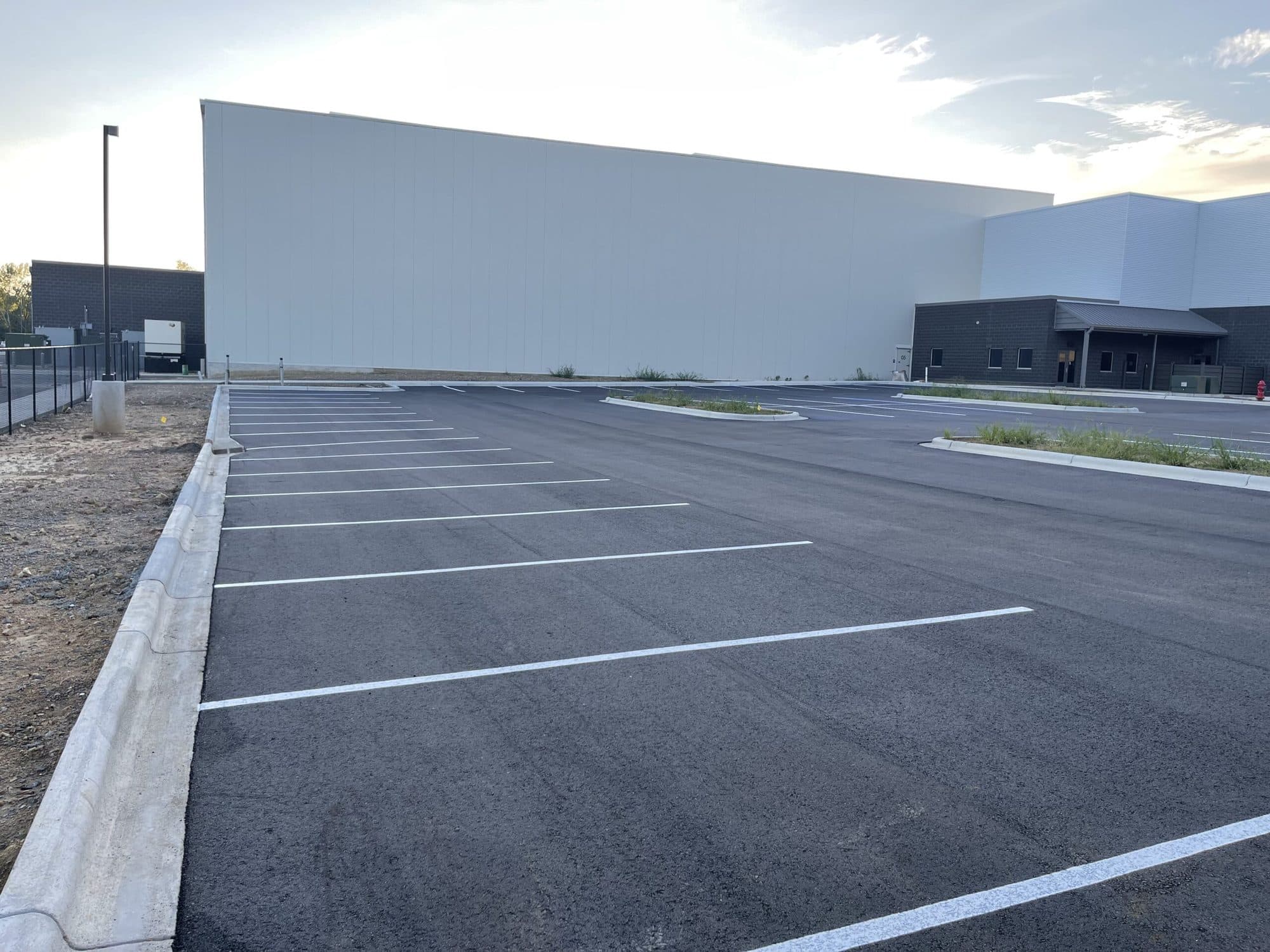 Clean drive lanes and stall markings across a commercial lot