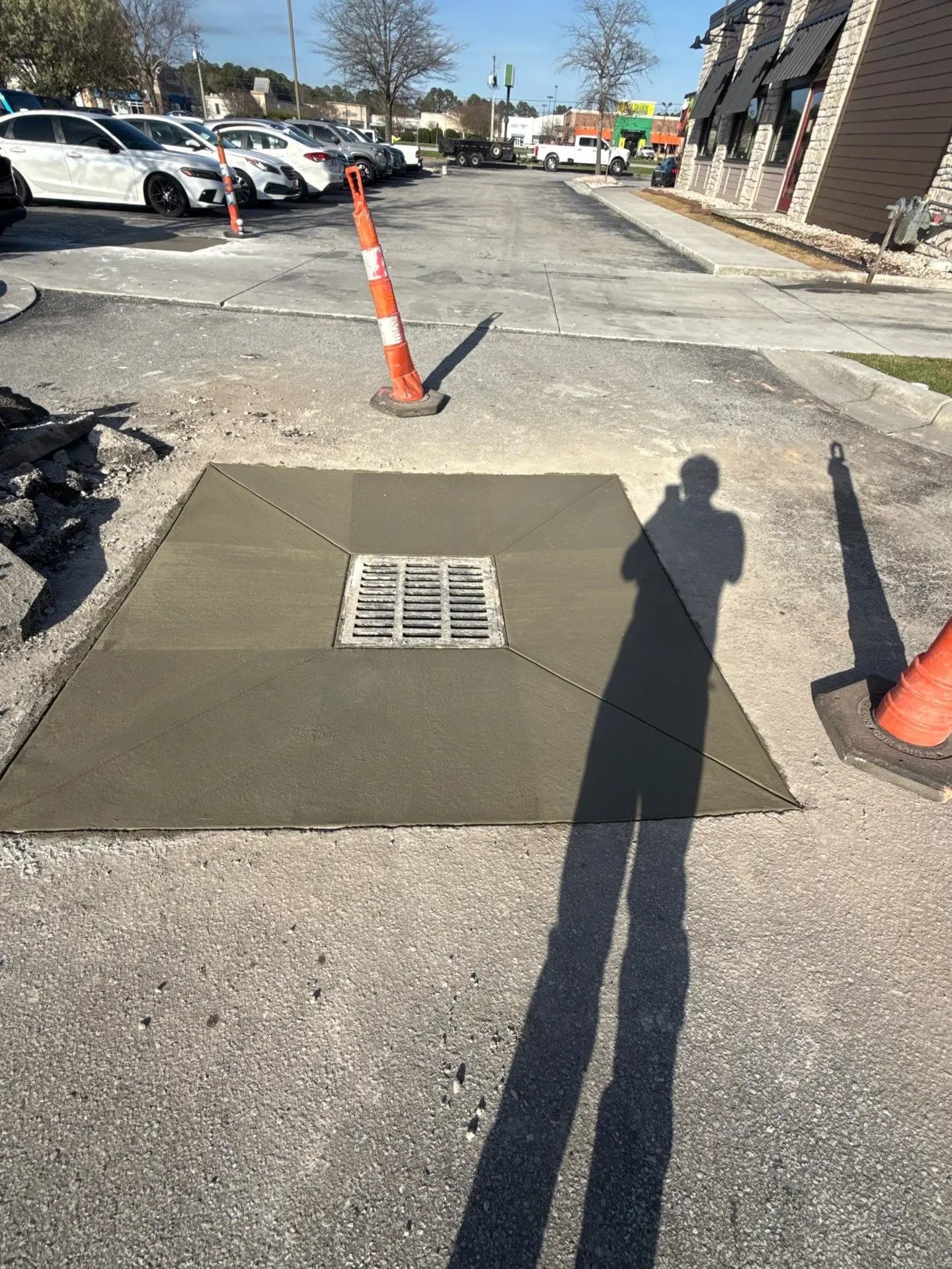 Crown Paving crew rebuilding a catch basin in a parking lot