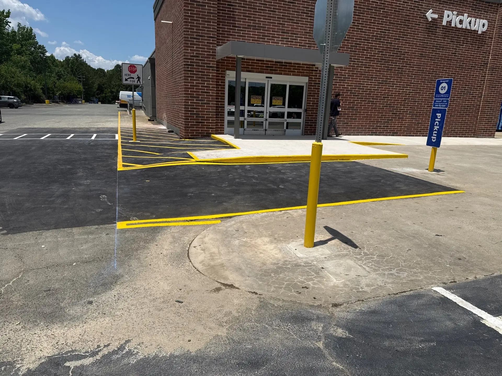 Asphalt patch repair in progress at a Walmart lot in Hillsborough
