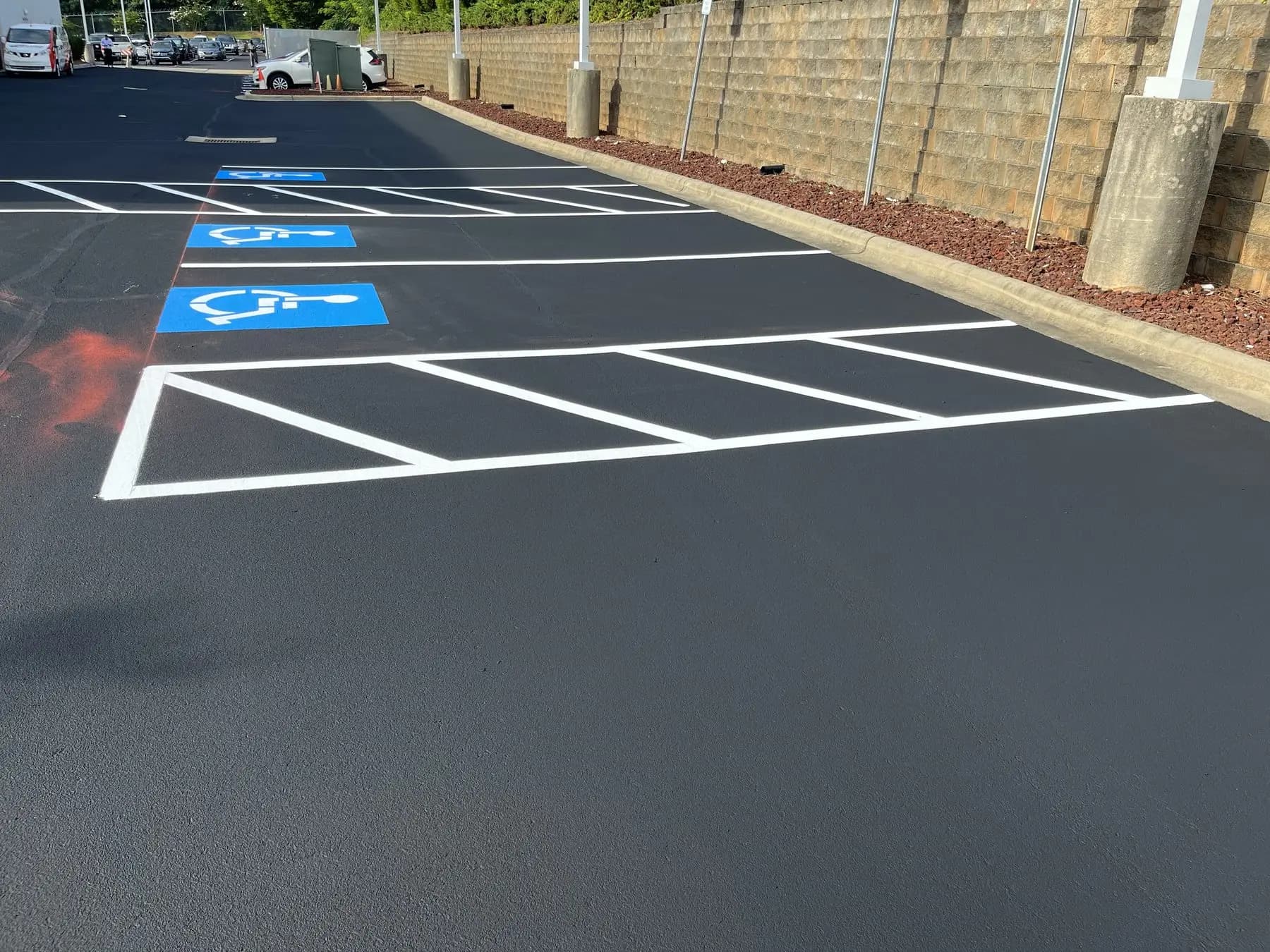 Accessible stalls and access aisles marked on a newly surfaced lot