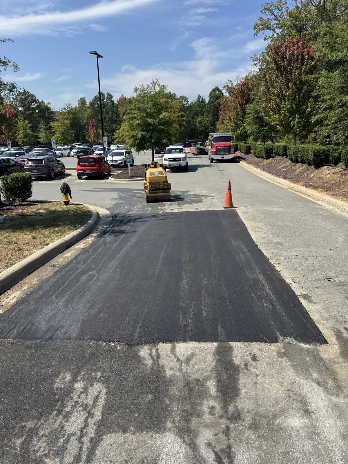 Completed asphalt patch blended into a commercial parking lot in Charlotte, NC