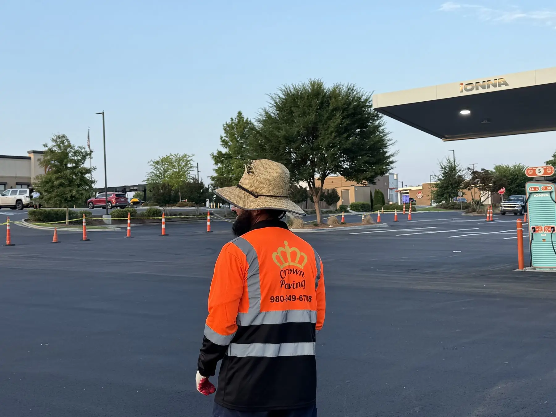 Crown Paving crew member walking a commercial lot during a site visit