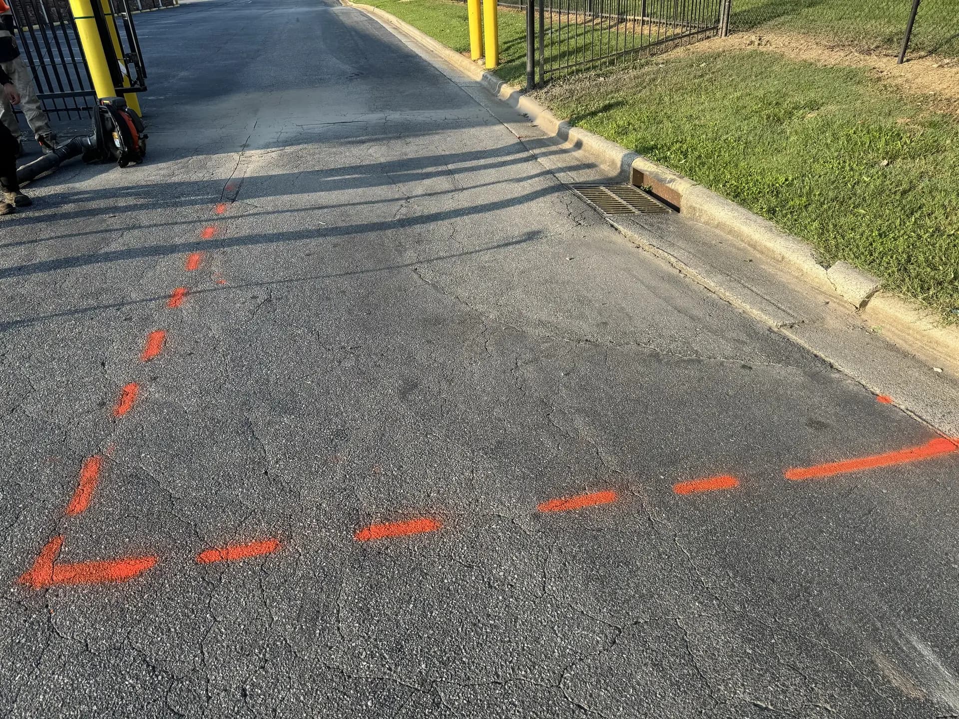 Patch area marked out on a commercial drive lane before saw cutting