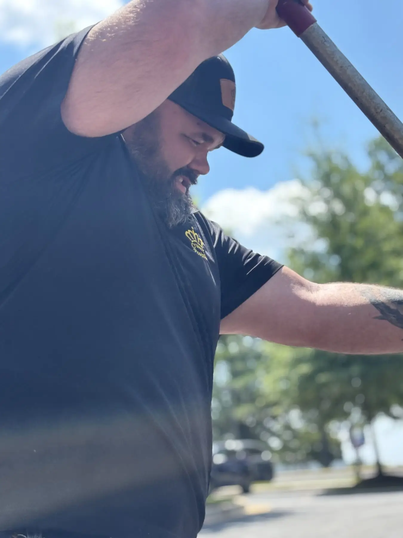 A Crown Paving crew member at work on a commercial job site
