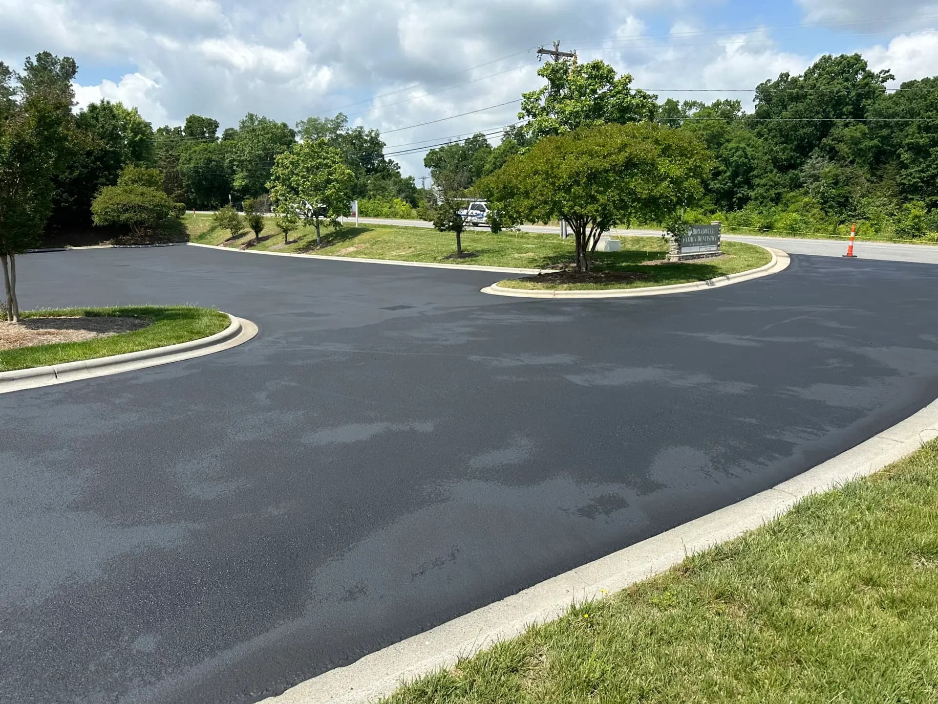 Freshly seal coated parking lot at a family dentistry practice in Kannapolis, NC