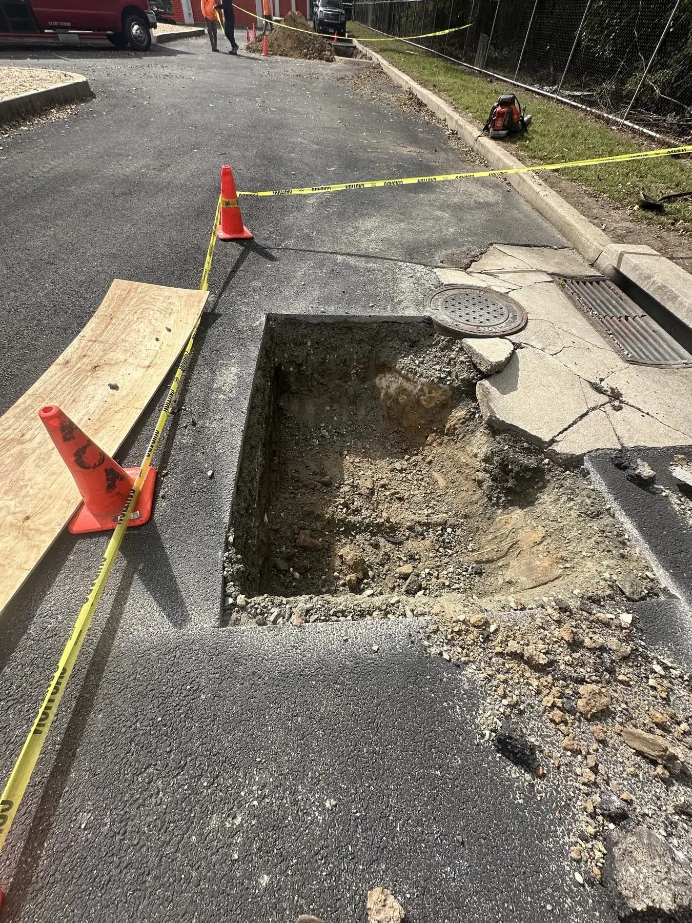 A sinkhole opened up beside a drain inlet, excavated and shored before repair
