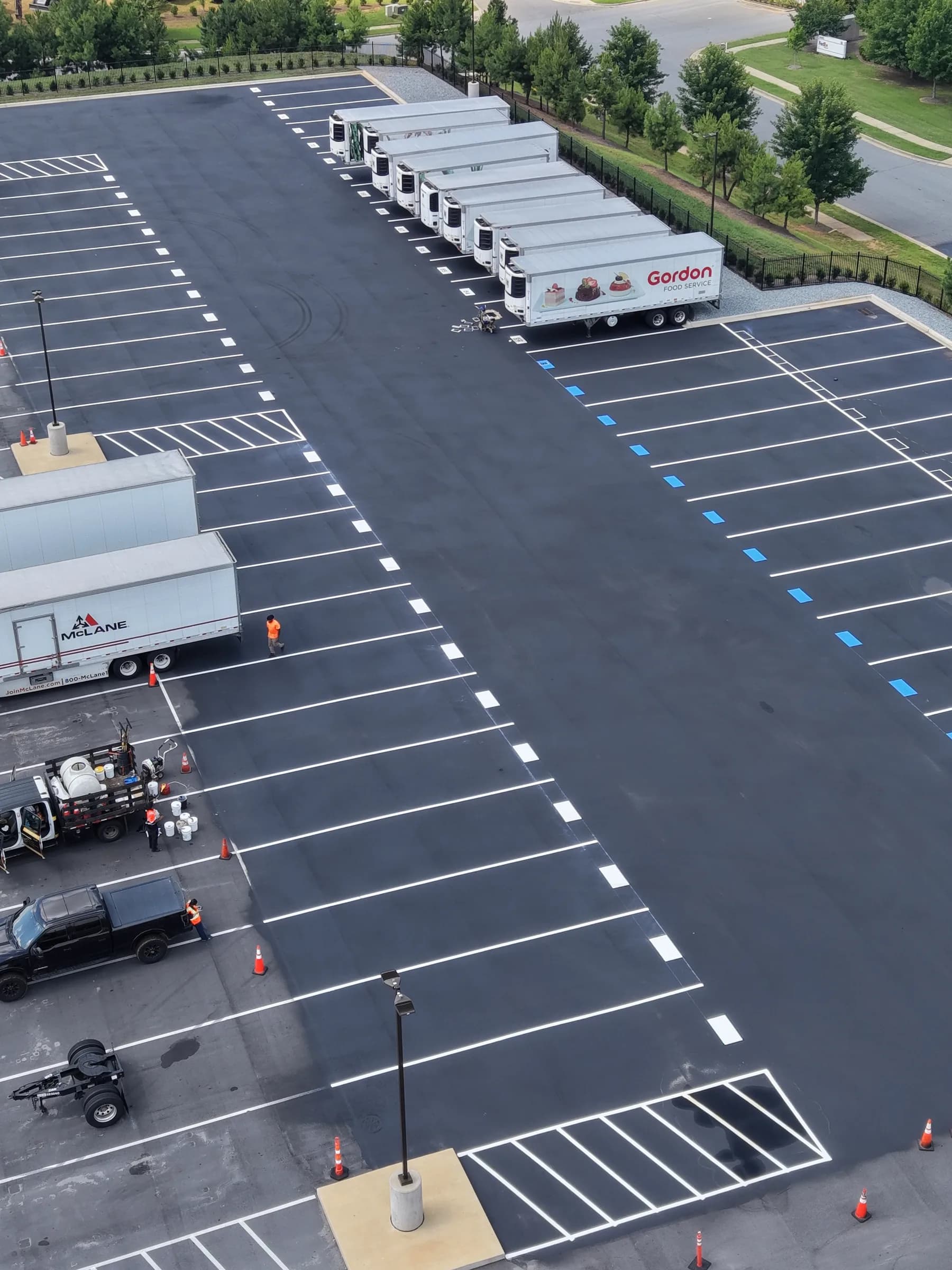 Crown Paving milling machine loaded on a lowboy trailer at an industrial building