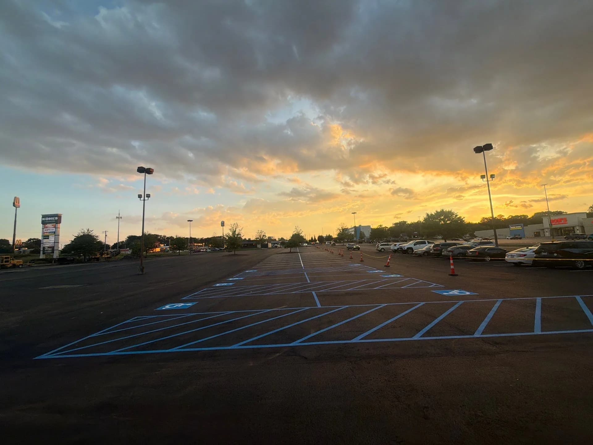 Freshly sealed retail parking lot with cones still in place